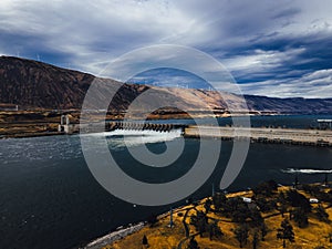 Aerial view of a bridge spanning across a John Day Dam on a sunny day