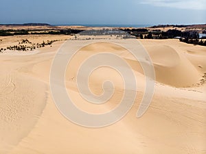 Aerial view of brown winding sand dunes in Muine