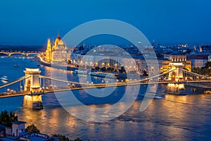 Aerial view of Budapest parliament and Chain bridge over Danube river at night Hungary