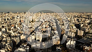 Aerial view of Buenos Aires city during the sunset with the view on skyscrapers, offices, living apartments and ocean in the backg