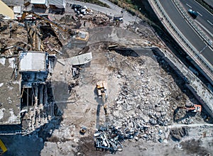 Aerial view of Building House Demolition and construction site Excavator with hydraulic crasher machine