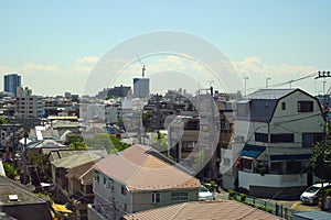 Aerial view of building and house of suburban area in Japan with clouds in background