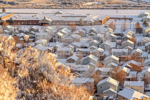 Aerial view of building and houses against a white landscape of fresh snow