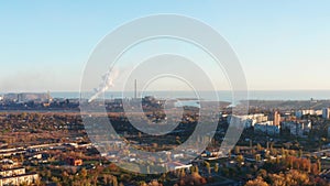 Aerial view. Buildings of an industrial city at sunset.