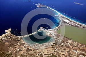 Aerial view of buildings, villas, and the beach on a natural spit of La Manga in Spain photo