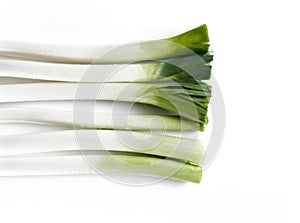 Aerial view of a bunch of leeks on a white table photo