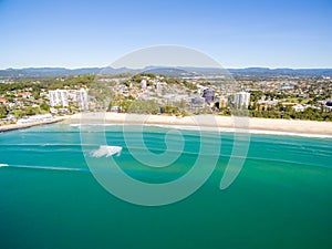 An aerial view of Burleigh Beach on a clear day with blue water