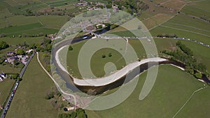 Aerial view of Burnsall, and its well known bridge in Wharfedale, Yorkshire Dales National Park, North Yorkshire, England, Britain
