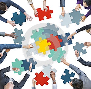 Aerial View of Business People Piecing Puzzle Pieces photo