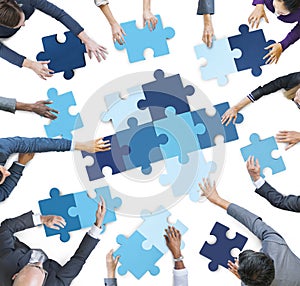 Aerial View of Business People Piecing Puzzle Pieces photo