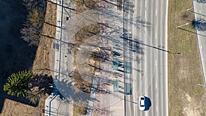 Aerial View of buss stop Multi-Lane Road with Tree Shadows