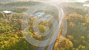 Aerial view of busy american freeway with fast moving cars and trucks. Interstate hauling of goods concept