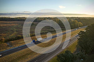 Aerial view of busy american freeway with fast moving cars and trucks. Interstate hauling of goods concept