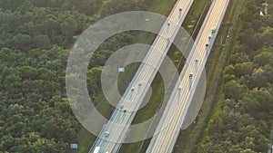 Aerial view of busy american highway with fast moving traffic at sunset. Interstate transportation concept