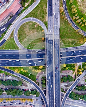 Aerial view of a busy road intersection with vehicles driving along Benfica Soccer stadium in Benfica district at twilight, Lisbon