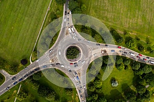 Aerial view of busy road roundabout at peak time rush hour