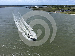 Aerial view of cabin cruiser boat moving along the coast of South Carolina