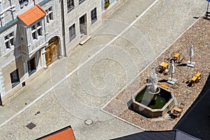 Aerial view of the cafe tables around the fountain on the square, sunny summer day