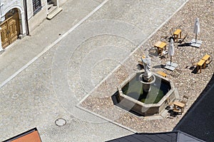 Aerial view of the cafÃ© tables around the fountain on the square, sunny summer day