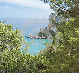 Aerial view of Cala Luna beach near Cala Gonone, Gulf of Orosei, Sardinia island, Italy. White sand beach with lime