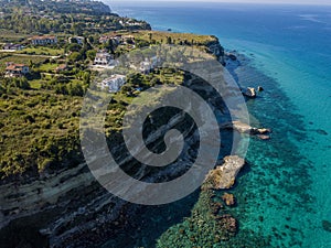 Aerial view of the Calabrian coast, cliffs overlooking the crystal clear sea and luxury villas. Riaci, Tropea, Italy