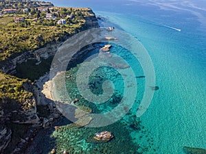Aerial view of the Calabrian coast, cliffs overlooking the crystal clear sea and luxury villas. Riaci, Tropea, Italy photo