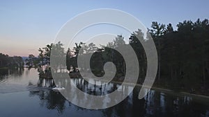 Aerial view on calm forest lake, tree forest backgrounds. Aerial view of trees on the lake shore. Forest lake landscape