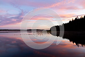 Aerial view of calm lake in summer at sunset. Picturesque landscape with fog.