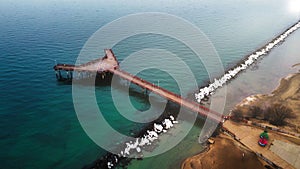 Aerial view of a calm seascape with the long pier