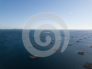 Aerial view of a calm waveless seascape with shell farms on the coast of Galicia, Spain