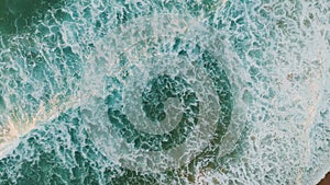 Aerial view calm waves splashing on sand shoreline making white foam. Sea swell