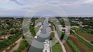 Aerial view of a canal harbor with moored boats and rafts. Foce Sisto.