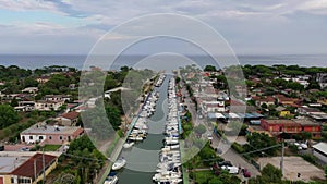 Aerial view of a canal harbor with moored boats and rafts. Foce Sisto.