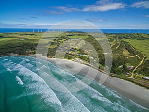 Aerial view of Cape Bridgewater beach, settlement, and wind farm in Victoria, Australia.