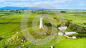 Aerial view on Cape Egmont lighthouse with farmland on the background. Taranaki region, New Zealand