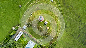 Aerial view on Cape Egmont lighthouse with farmland on the background. Taranaki region, New Zealand