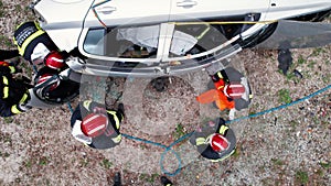 Aerial view Car Crash Traffic Accident. Firefighters Rescue Injured Trapped Victims. Firefighters work on an extrication
