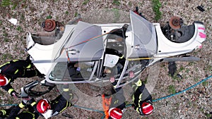 Aerial view Car Crash Traffic Accident. Firefighters Rescue Injured Trapped Victims. Firefighters work on an extrication