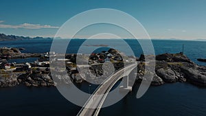 Aerial view of a car crossing a bridge in sunset, Reinefjorden, Lofoten, Norway