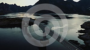 Aerial view of a car crossing a bridge in sunset, Reinefjorden, Lofoten, Norway