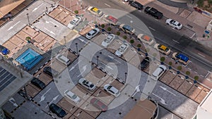 Aerial view of car crowded parking lot near apartment buildings all day timelapse.