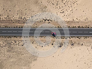 Aerial view of a car in the desert valleys of the island of Lanzarote, Canary Islands, Spain