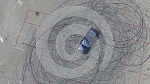 Aerial view of a car and drifting marks left on pavement