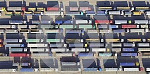 Aerial view of a car parking lot with many cars and trucks