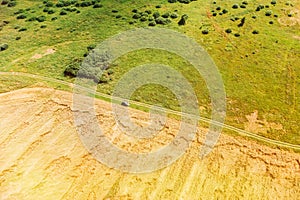 Aerial View Of Car SUV Parked Near Countryside Road In Summer Field Rural Landscape. Yellow Wheat Field In Summer Season
