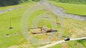 Aerial view car vehicle travel in truso valley pass historical ruins site under reconstruction in Georgia