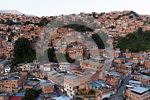 Aerial view of Caracas at sunset with the Petare neighborhood, the largest slum in Venezuela and latin america, with the Avila