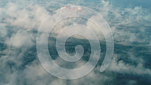 Aerial view of cargo container  ship sails in sea fog, crane vessel working for delivery of delivery containers