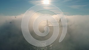 Aerial view of cargo container  ship sails in sea fog, crane vessel working for delivery of delivery containers