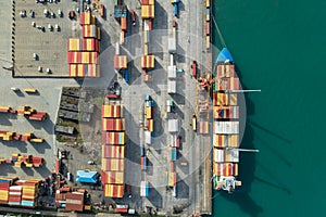 Aerial view of cargo port with container terminal at dock. International freight logistics and trade commerce